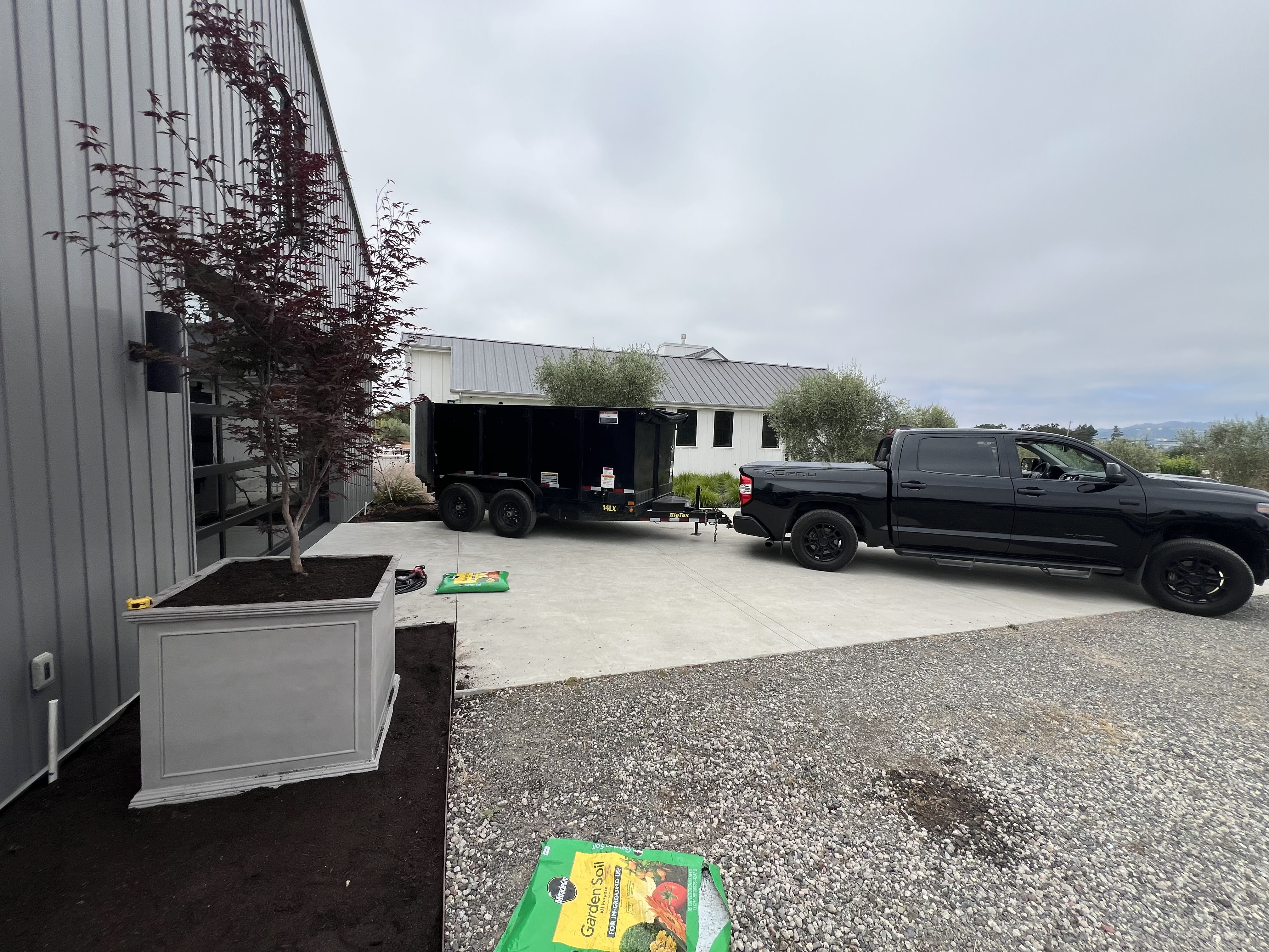 Truck and BigTex dump trailer on a Napa job site